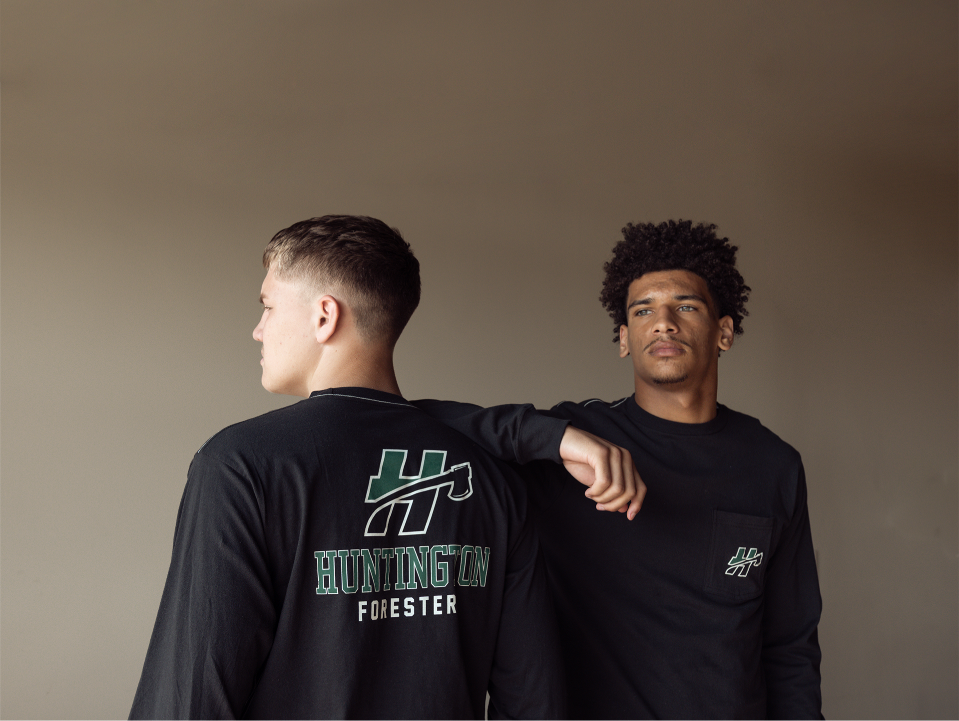 Two men posing wearing black long sleeves